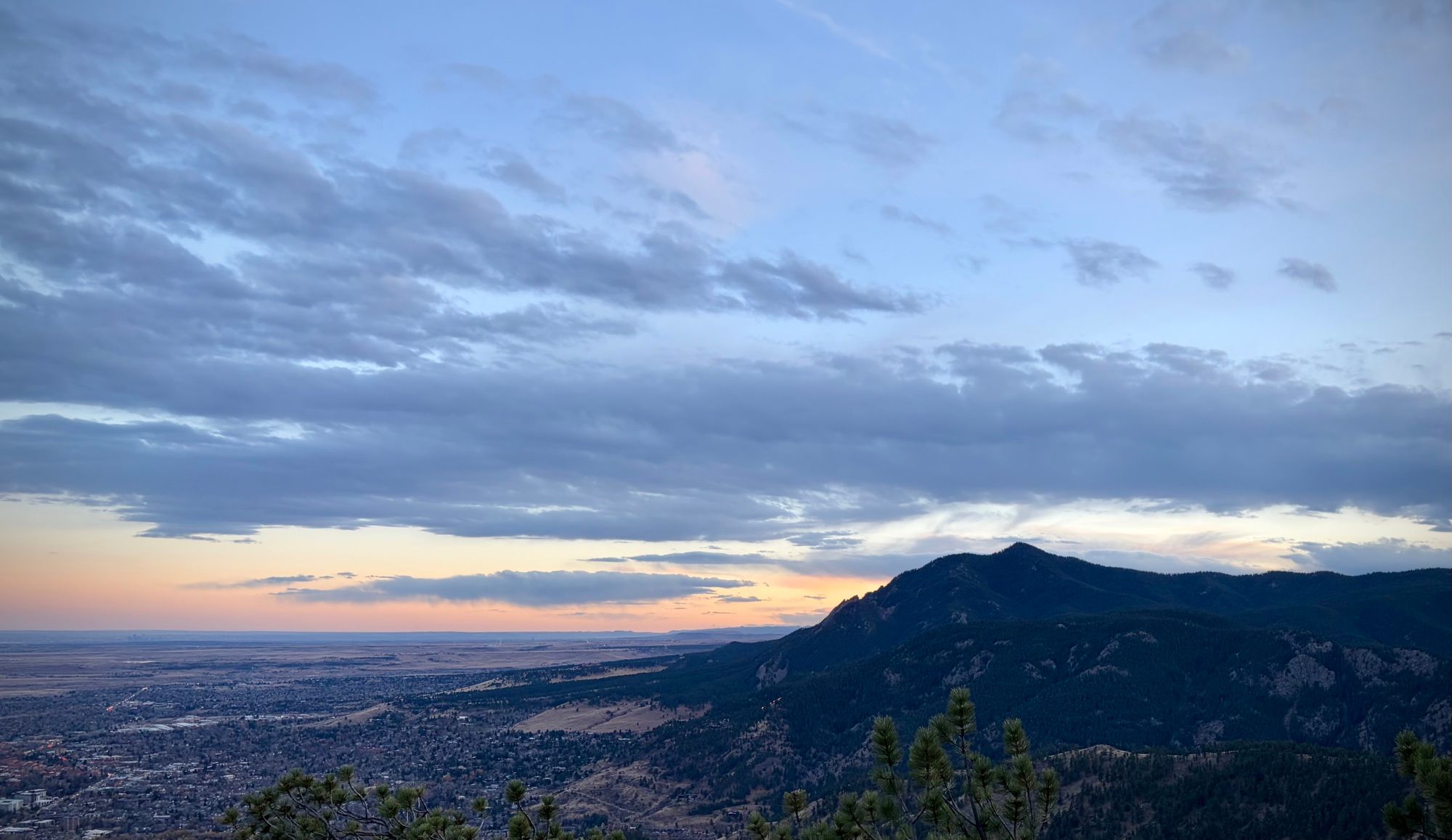 mountains and plains, with clouds at sunset.